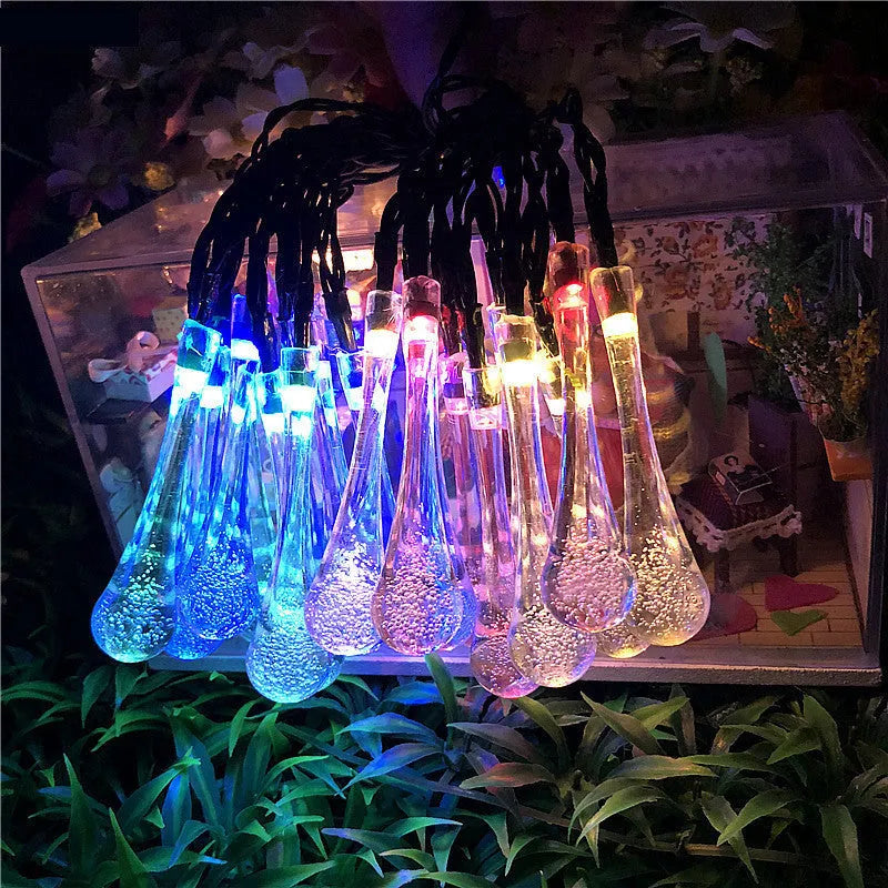 String of solar-powered LED garden lights with water drop-shaped pendants on a 6.5 metre cable.