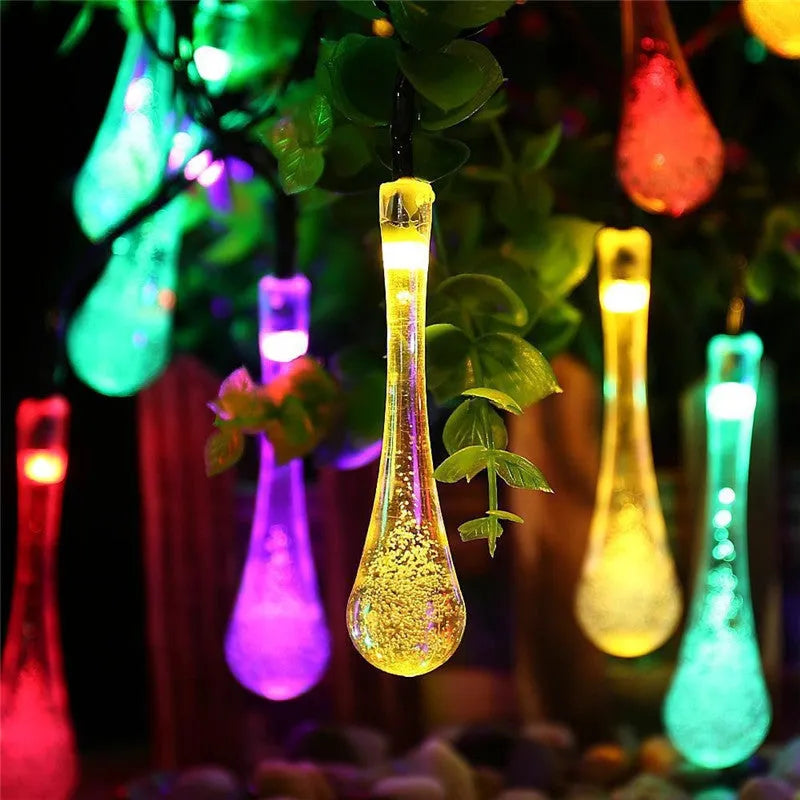 String of solar-powered LED garden lights with water drop-shaped pendants on a 6.5 metre cable.