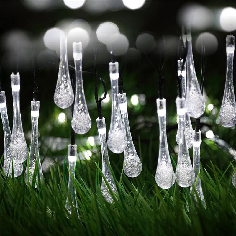 String of solar-powered LED garden lights with water drop-shaped pendants on a 6.5 metre cable.