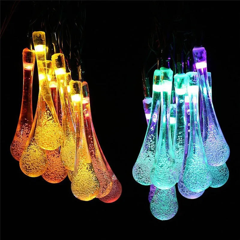 String of solar-powered LED garden lights with water drop-shaped pendants on a 6.5 metre cable.