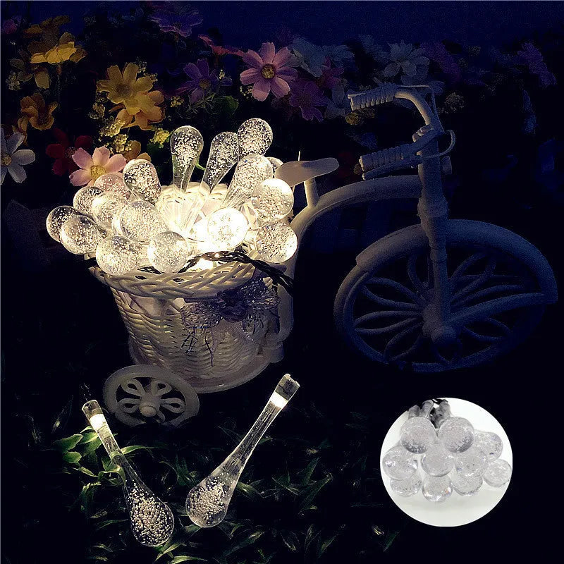 String of solar-powered LED garden lights with water drop-shaped pendants on a 6.5 metre cable.