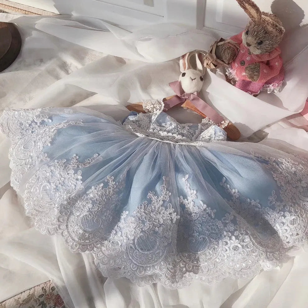 Ocean blue baby girl princess dress with lace detailing, shown on a size chart.