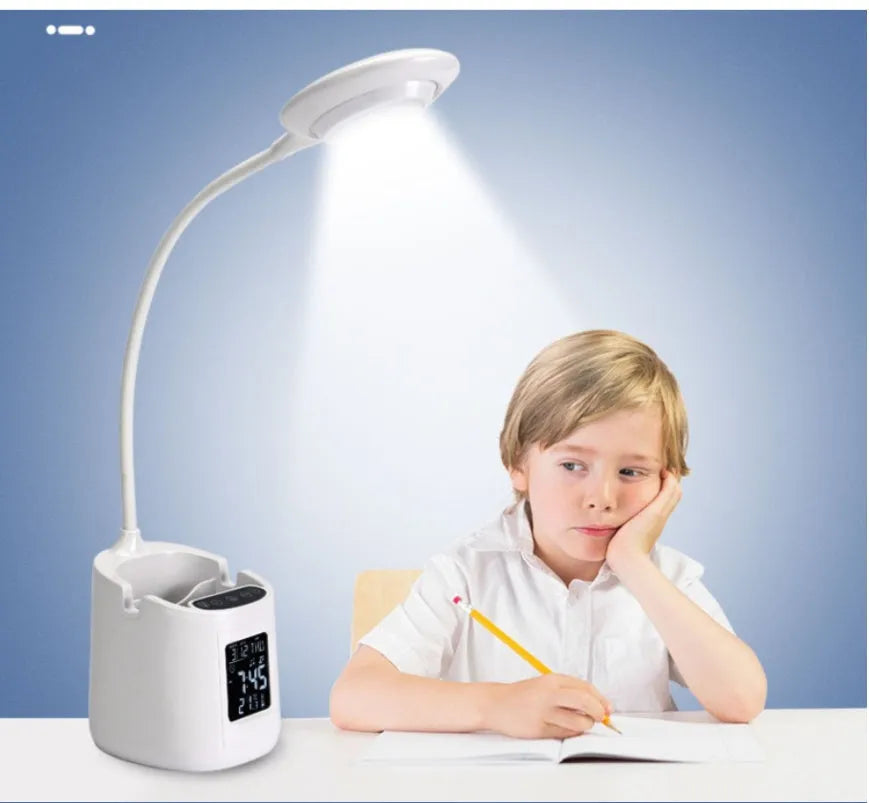 White USB-powered desk lamp with touch control on a wooden desk.