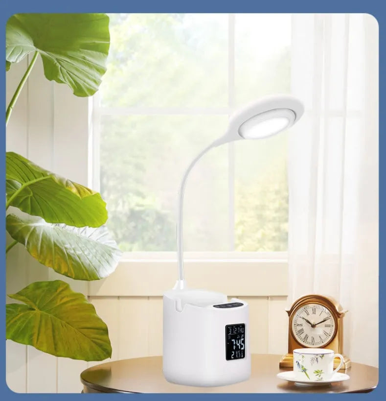 White USB-powered desk lamp with touch control on a wooden desk.