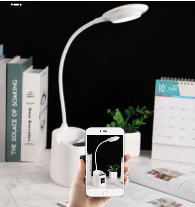 White USB-powered desk lamp with touch control on a wooden desk.