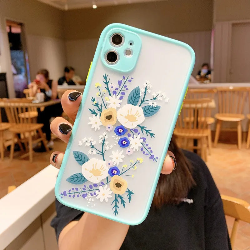 Pink Lavender matte frame iPhone case with painted blue cartoon flowers on a TPU back cover.
