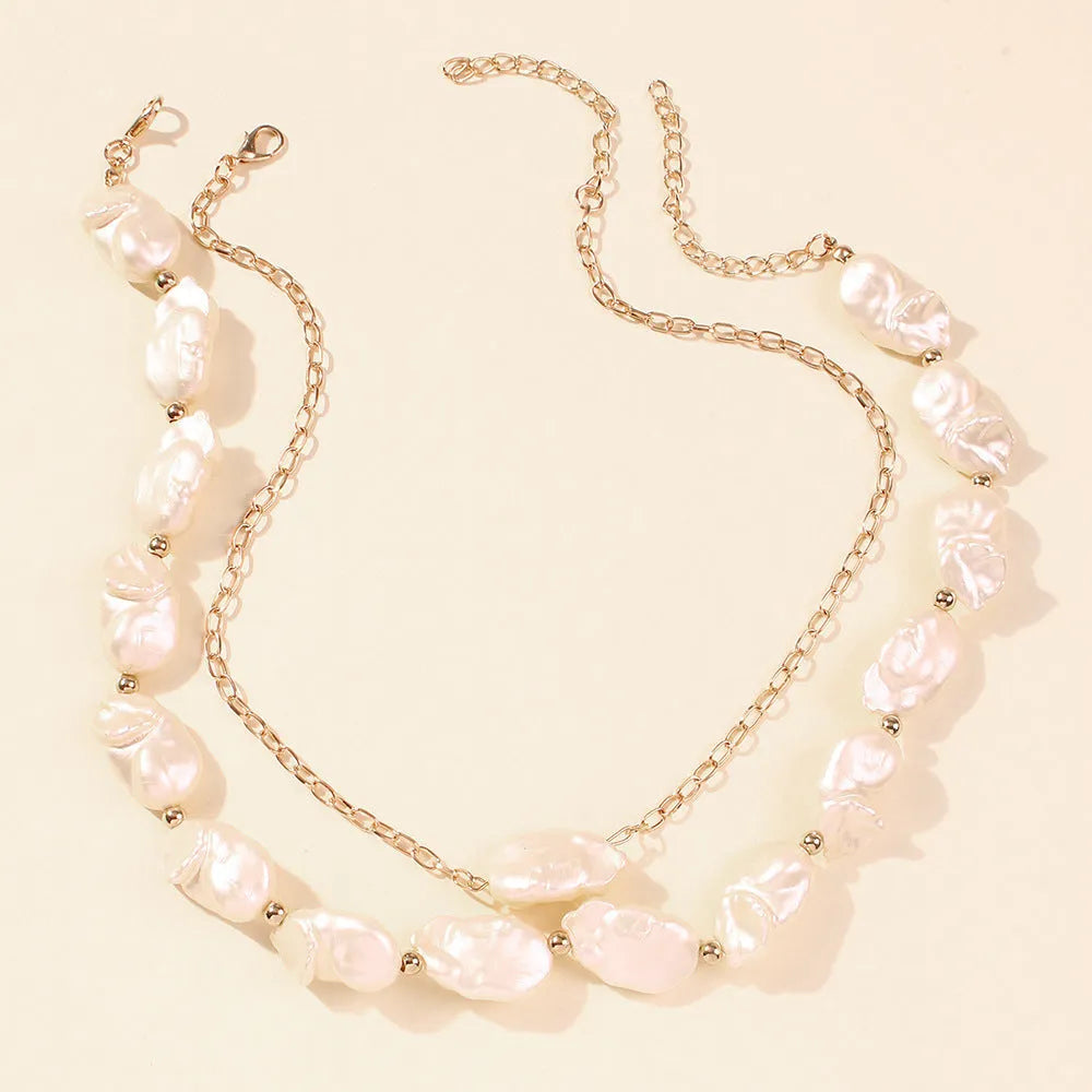 Gold irregular pearl necklace on woman clavicle chain with imitation pearls and alloy frame
