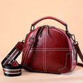 Round leather handbag with soft handle showing zipper opening and portable dimensions