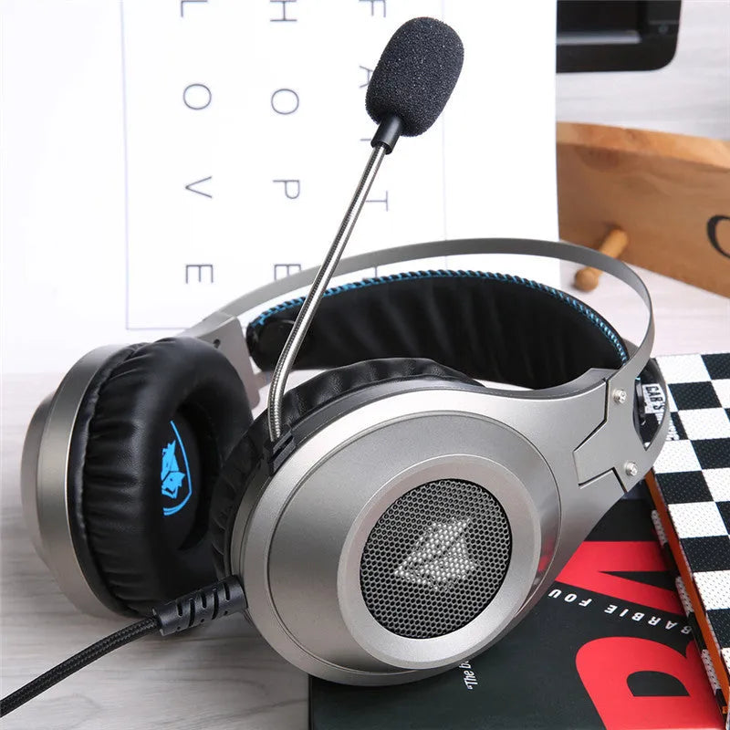 Black wired USB over-ear computer gaming headset with a microphone on a desktop.