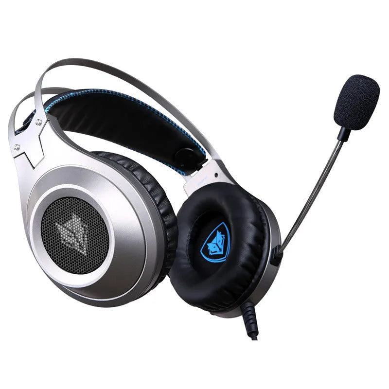 Black wired USB over-ear computer gaming headset with a microphone on a desktop.