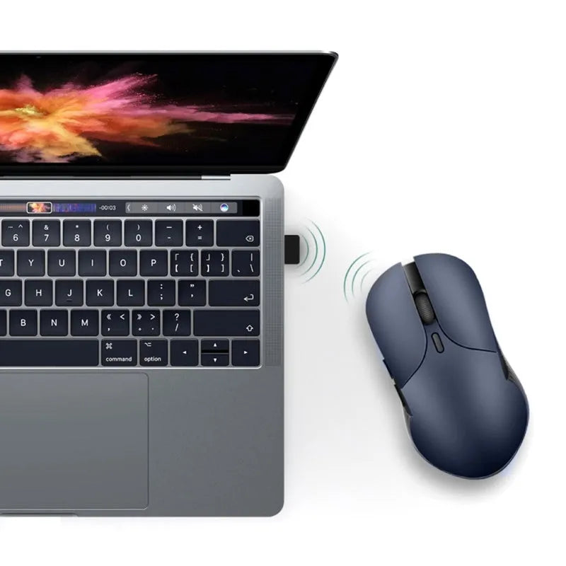 Blue wireless voice translation mouse with scroll wheel and voice control button on a desk.