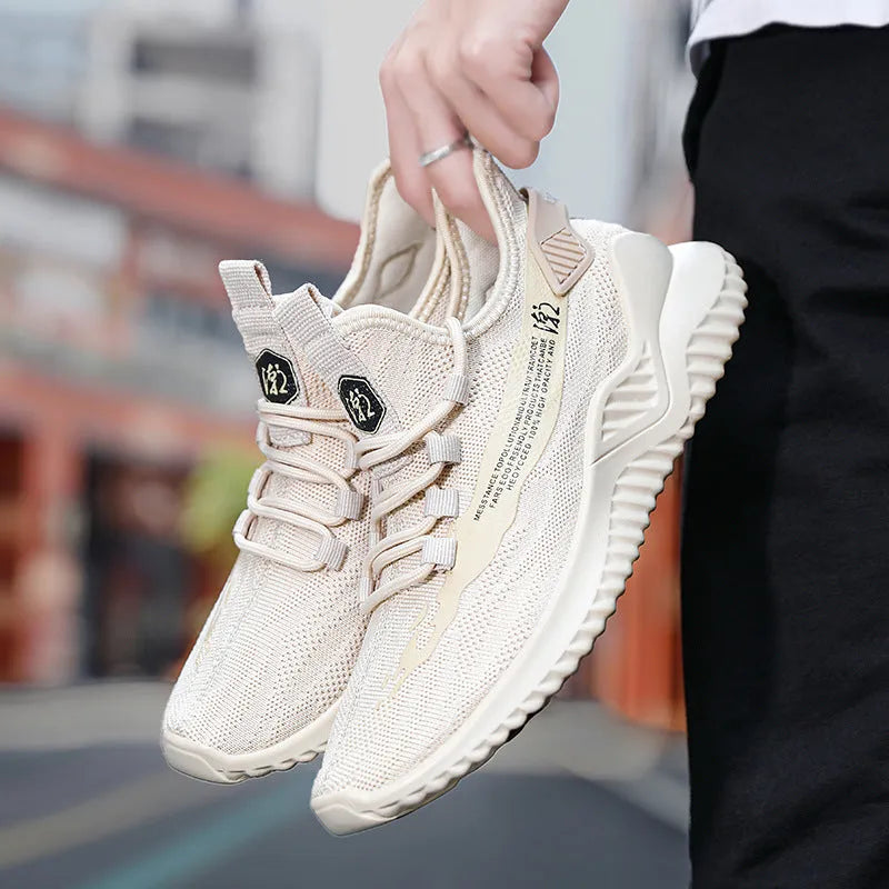 Men's white mesh sports shoes with rubber soles and round toe on neutral background