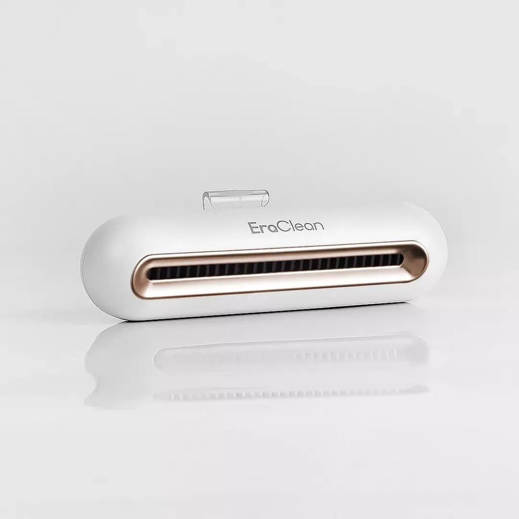 Rose gold USB-powered car air purifier and deodoriser with push-button control.