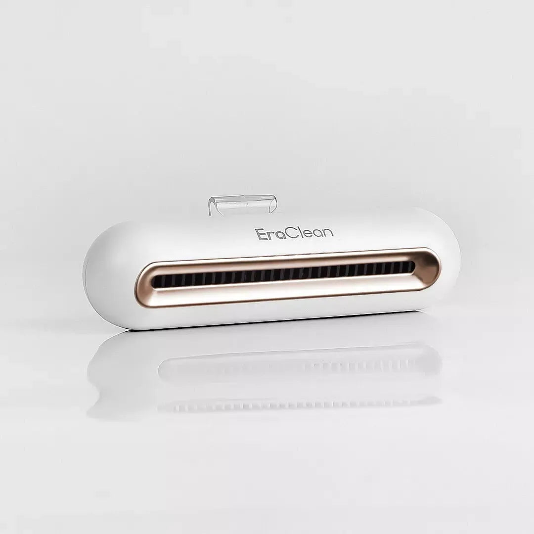 Rose gold USB-powered car air purifier and deodoriser with push-button control.