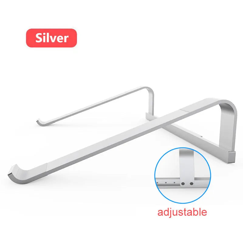 Aluminium alloy laptop air stand in silver, hollowed out design, supporting an open notebook on a desk.