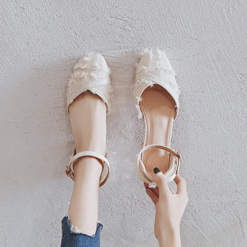 Women's apricot suede D'Orsay flats with an ankle strap and 3cm low heel on a wooden floor.