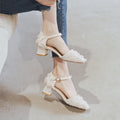 Women's apricot suede D'Orsay flats with an ankle strap and 3cm low heel on a wooden floor.