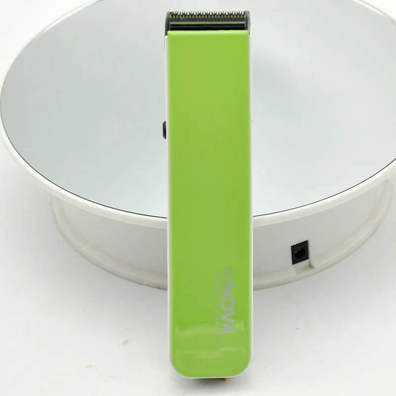 Black electric hair clipper with removable blade head on a white background.