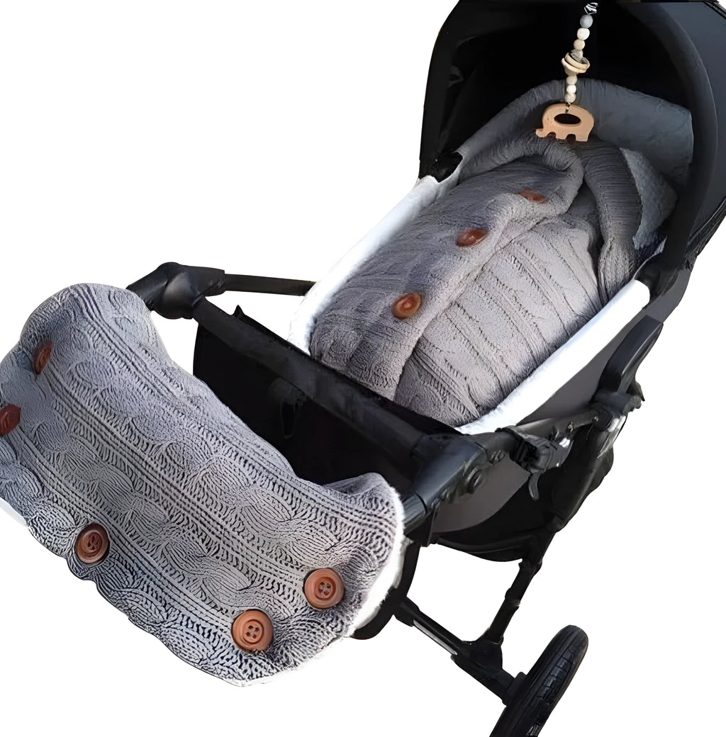 Baby sleeping bag in beige with lamb wool and acrylic material, button opening, and matching gloves on pram