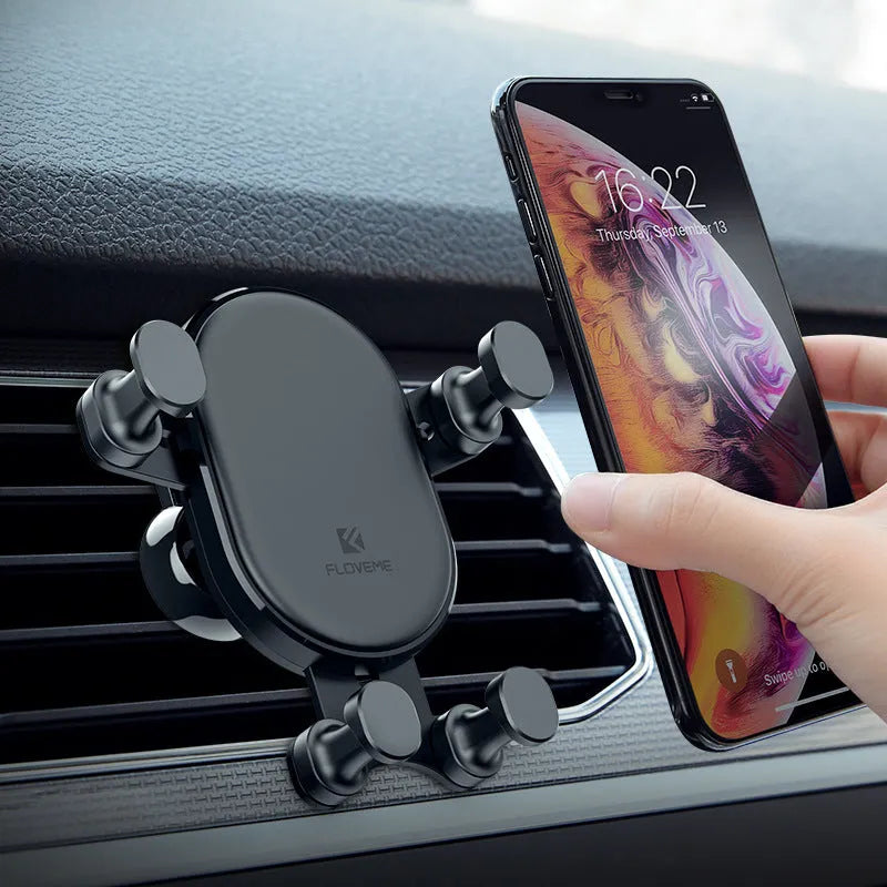 Black car mobile phone holder with gravity bracket mounted in vehicle air vent showing 360-degree rotation