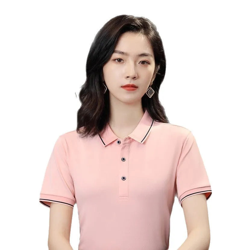 Beautician wearing a short-sleeved light blue polo shirt with asymmetric detail in a salon setting