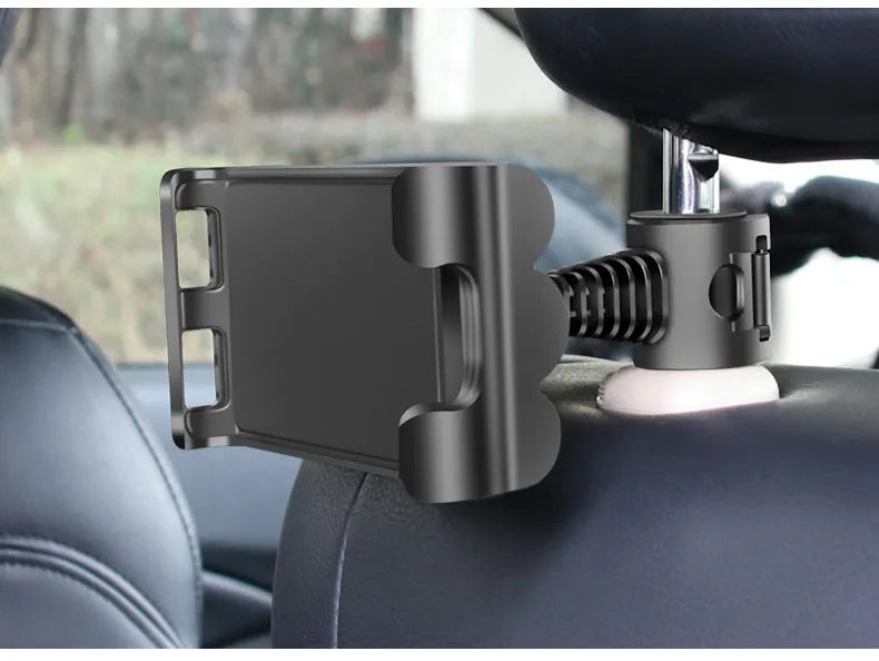 Black universal car headrest tablet holder mounted on a car seat, showing adjustable arm and 360-degree rotation.