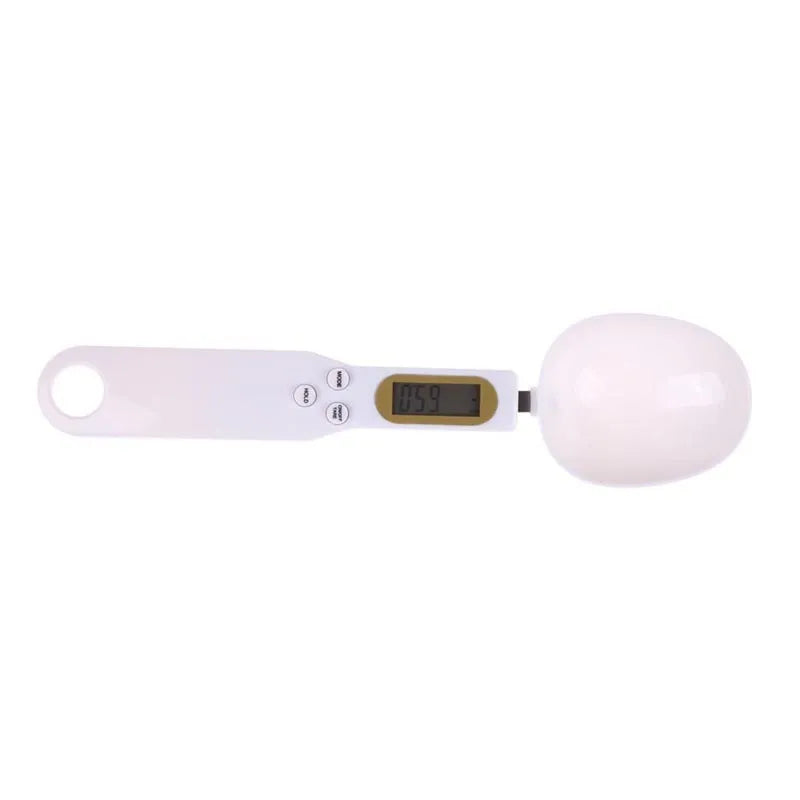 White digital spoon kitchen scale with LCD display showing weight measurement.