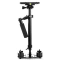 Black aluminium handheld camera stabiliser with adjustable height on a table.