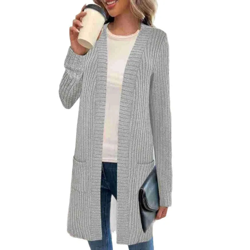 Long sleeve loose fit knitted cardigan jacket in black, shown on a hanger.