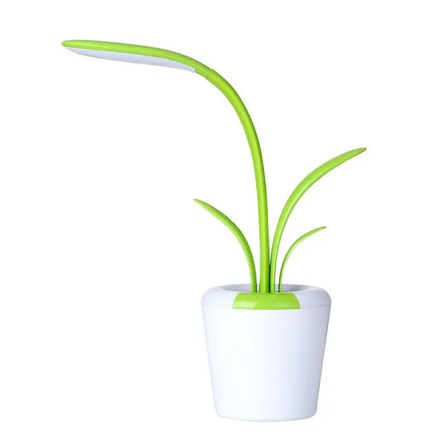 Modern rechargeable desk lamp with plant shape design in pink, showing touch control on a wooden end table