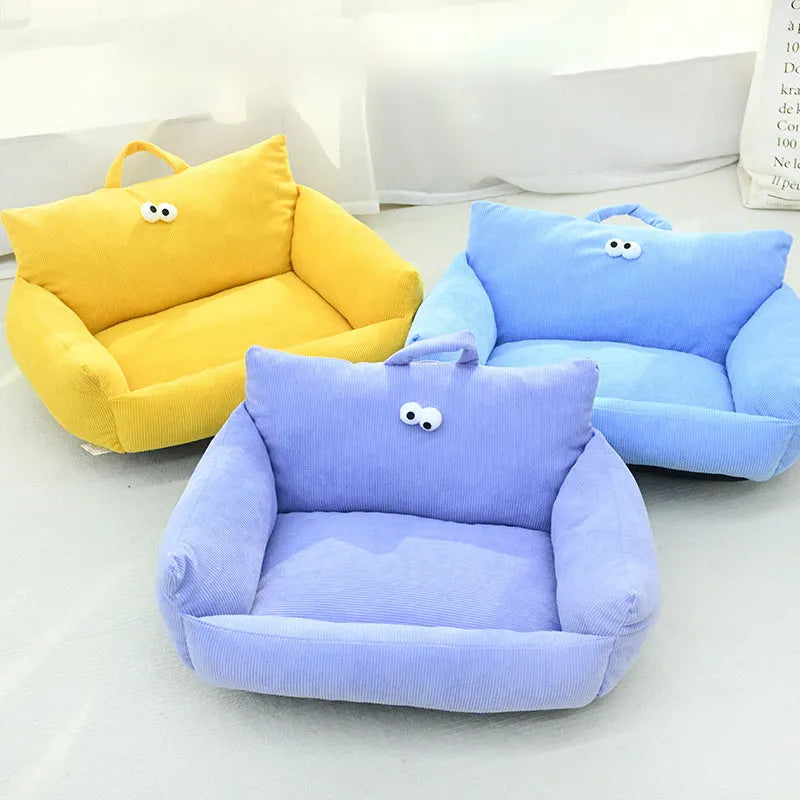 Cartoon big eye pet bed cushion for small dogs and cats in blue, shown with removable sticky eyes.