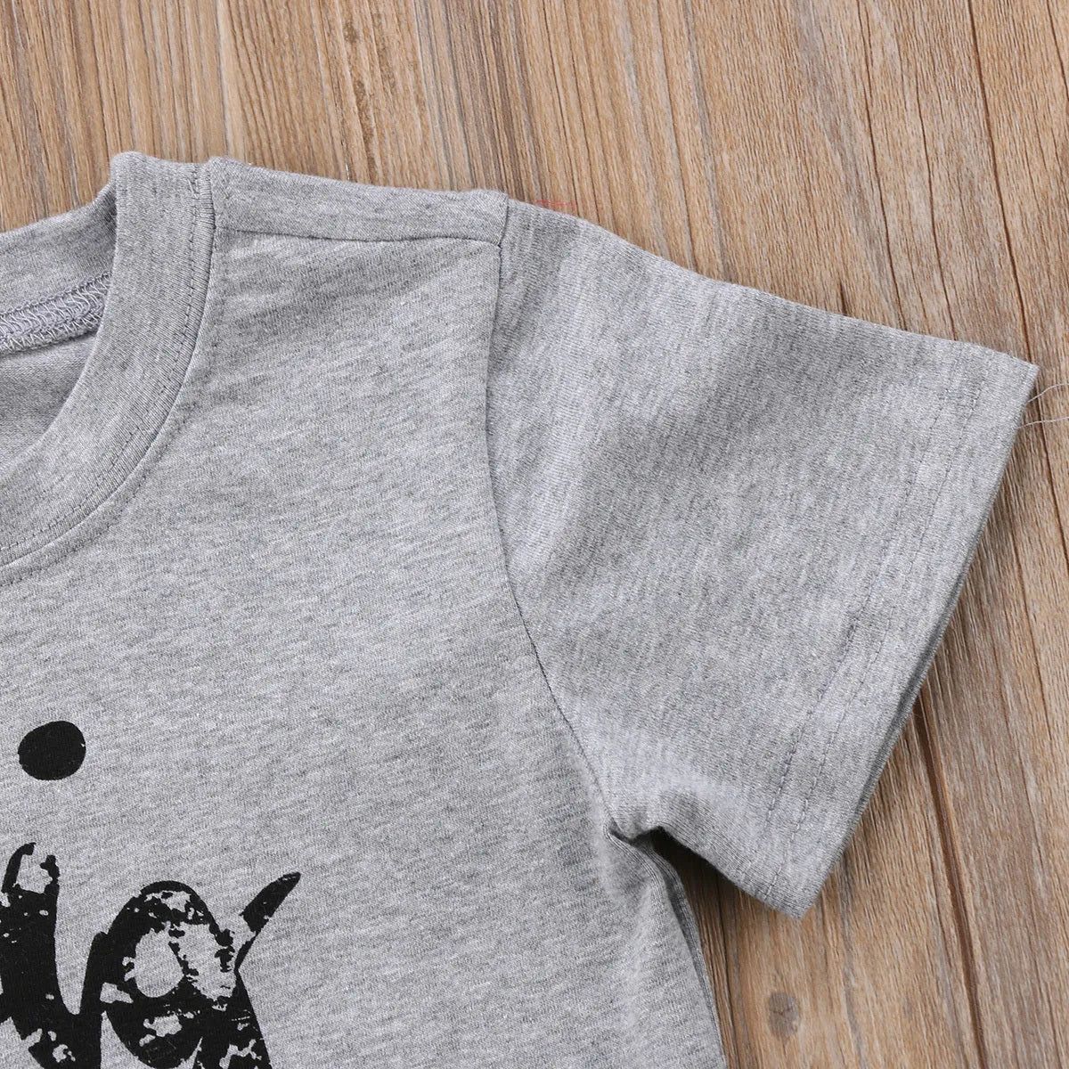 Grey printed cotton t-shirt shown in sizes for children and adults.