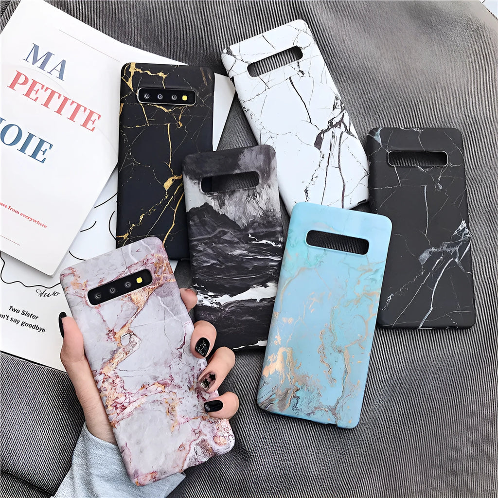 Samsung Galaxy phone case with a white and grey marble pattern on a black polycarbonate back cover.