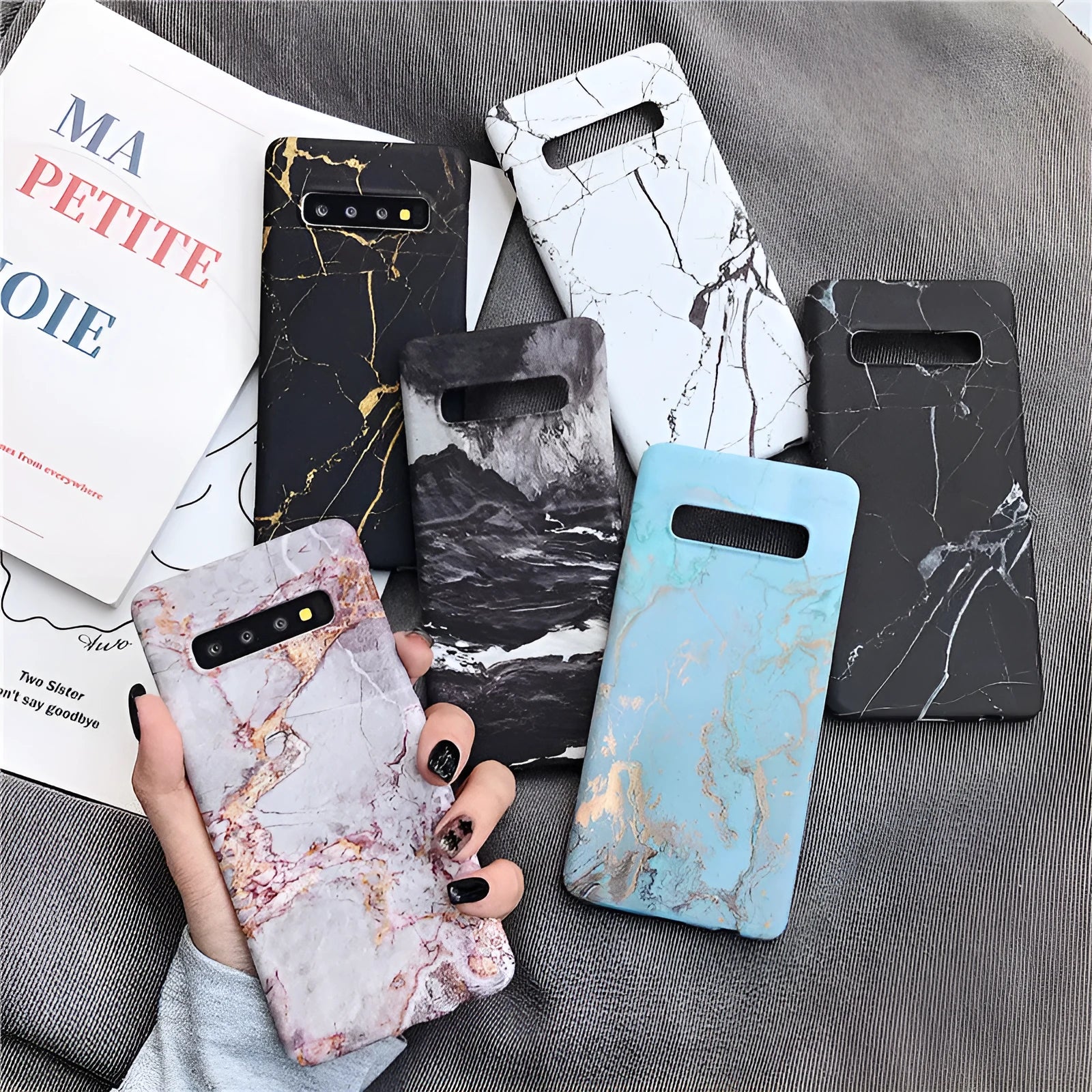 Samsung Galaxy phone case with a white and grey marble pattern on a black polycarbonate back cover.
