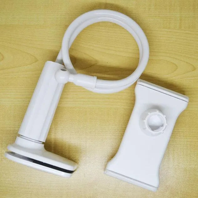 Black bedside oversize flat panel phone handset with a long flexible arm on a wooden table.