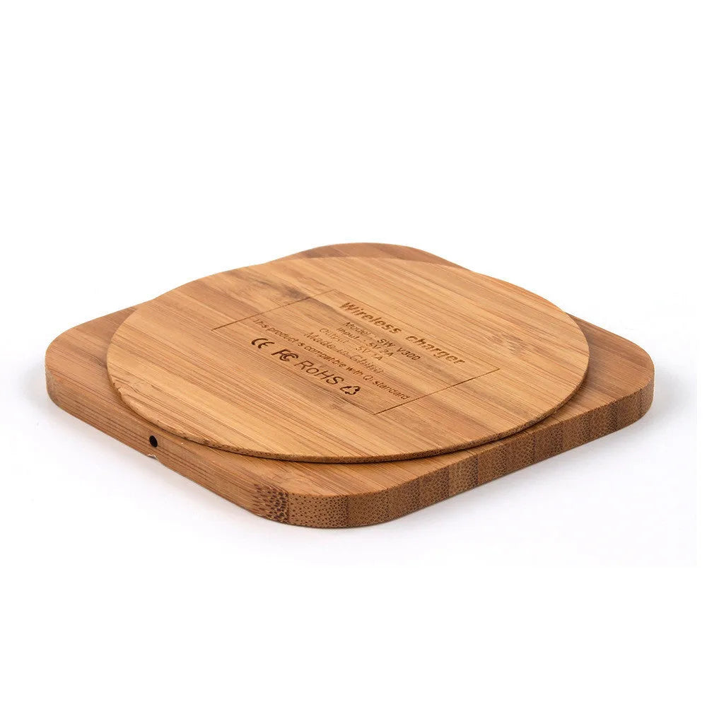 Square brown wooden bamboo 5W Qi wireless charging pad on a table