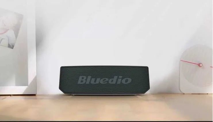Black BS-6 cloud smart speaker showing front grill and compact rectangular body.