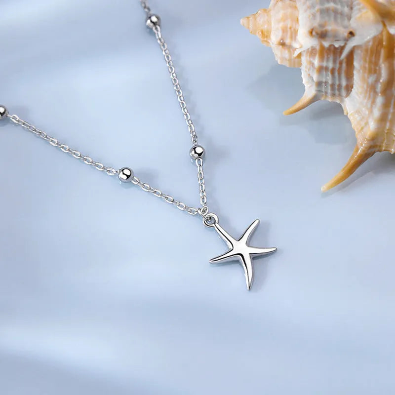 Adjustable sterling silver anklet with a small starfish charm and round beads on a fine chain.