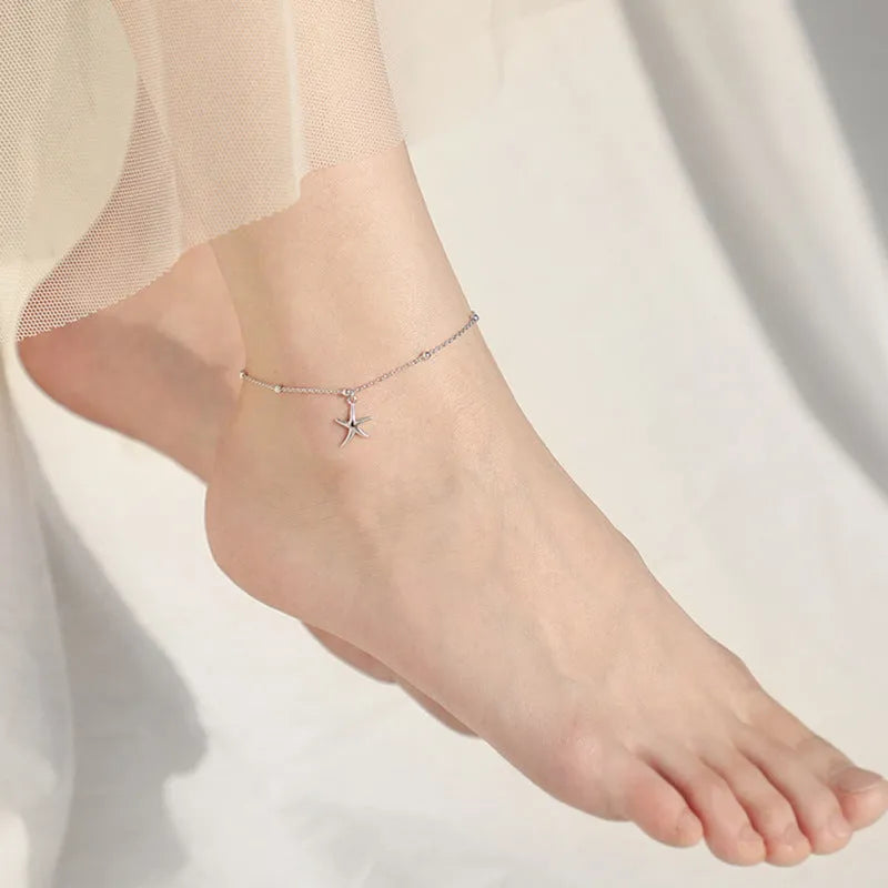 Adjustable sterling silver anklet with a small starfish charm and round beads on a fine chain.