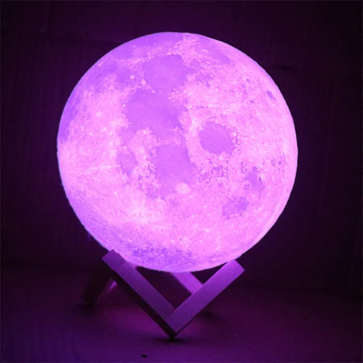 3D printed white moon lamp with detailed lunar surface texture on a wooden holder.