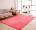 White plush rectangular rug with non-slip dot bottom on wooden flooring