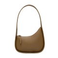 Small half moon shaped leather women's shoulder bag with a wide strap, shown in light brown.
