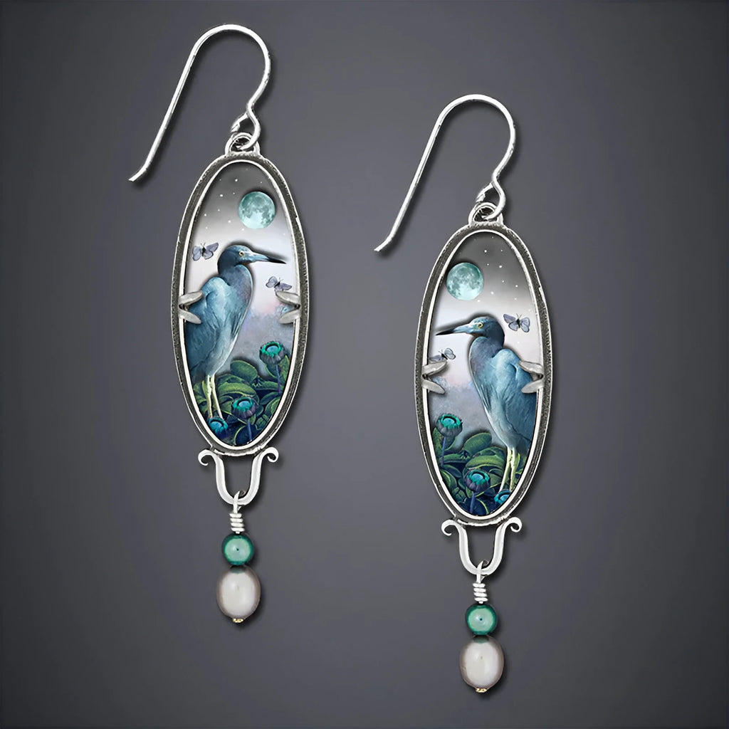 Silver retro-style drop earrings with a creative bird and flower design.