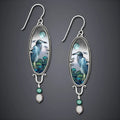 Silver retro-style drop earrings with a creative bird and flower design.