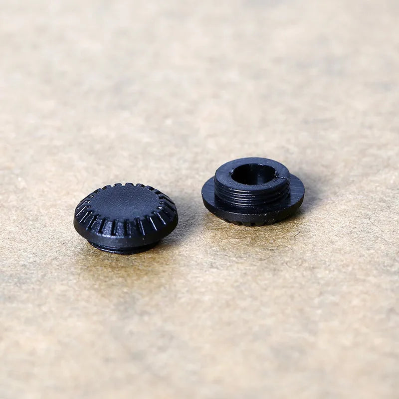 Black plastic camera shutter button with 1cm diameter for mechanical shutter replacement