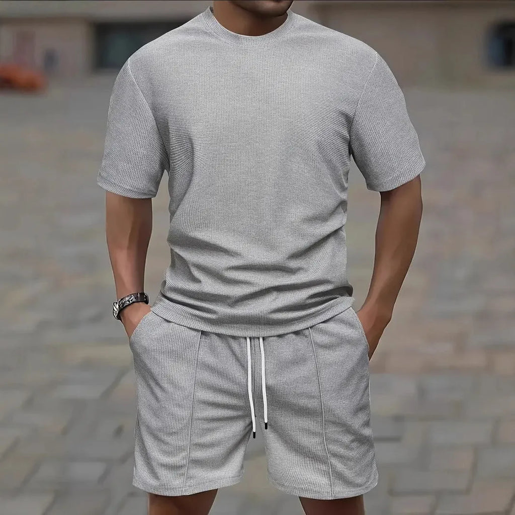 Man wearing a light apricot waffle texture short sleeve blouse and matching shorts for summer.