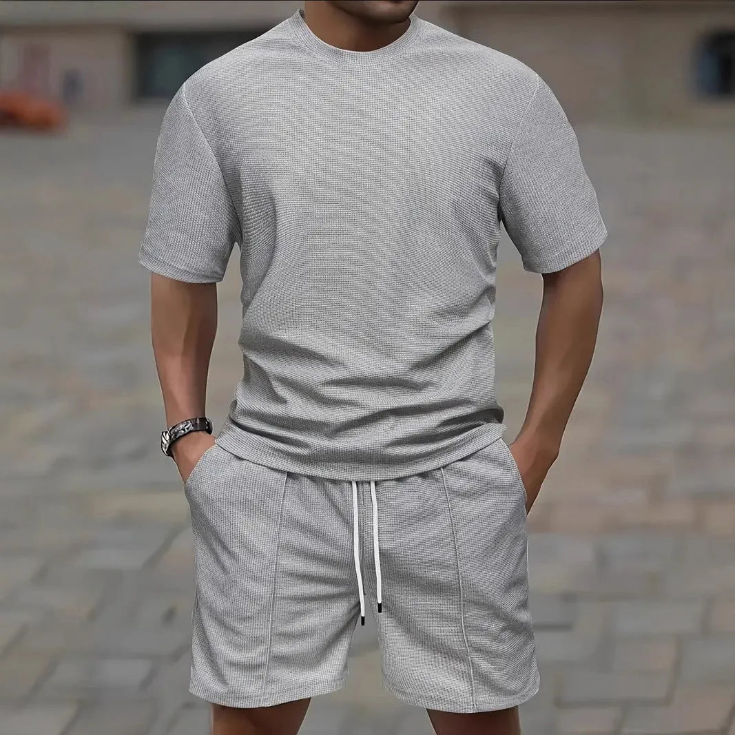 Man wearing a light apricot waffle texture short sleeve blouse and matching shorts for summer.