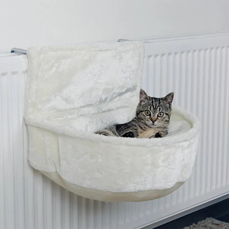 Iron frame cat hammock with soft fleece lining in grey, attached to a cage for a small cat.