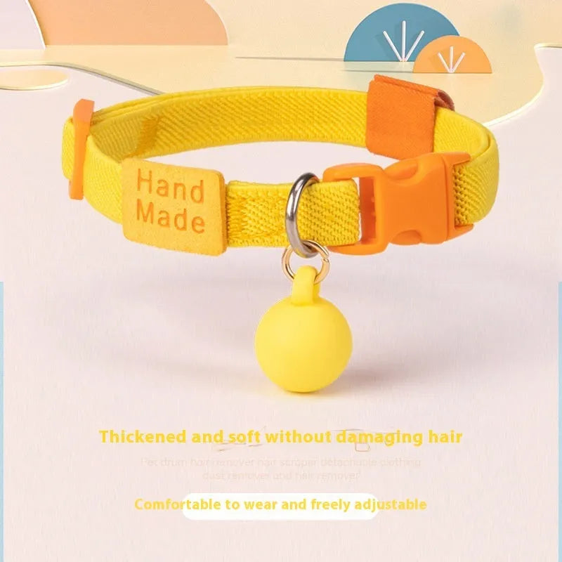 A small, elastic monochrome dog collar in sky blue with a plastic buckle, laid flat.
