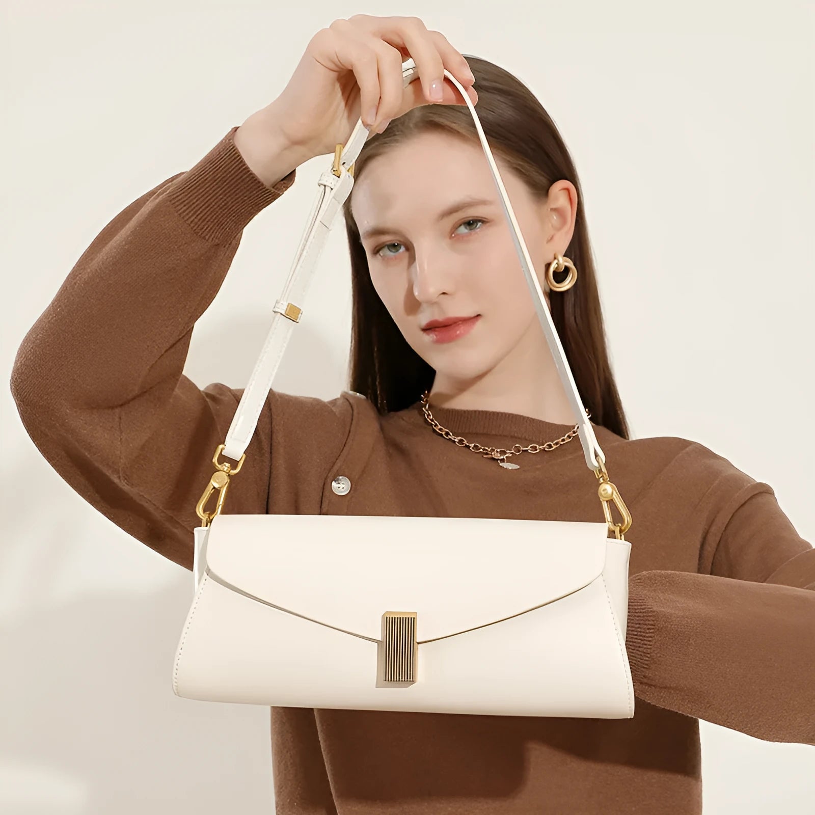 Women's leather cross-body bag with clamshell design and pillow shape in multiple colours